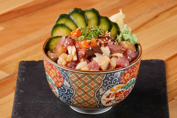 Mixed sashimi with makanai sauce on sushi rice bowl.